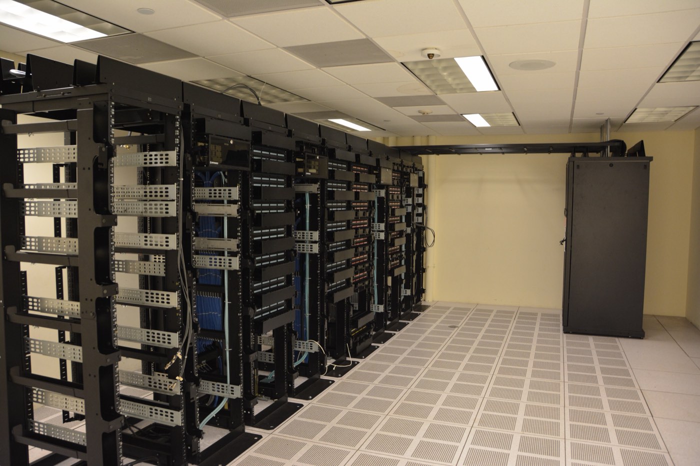 A long aisle of server racks in a data centre