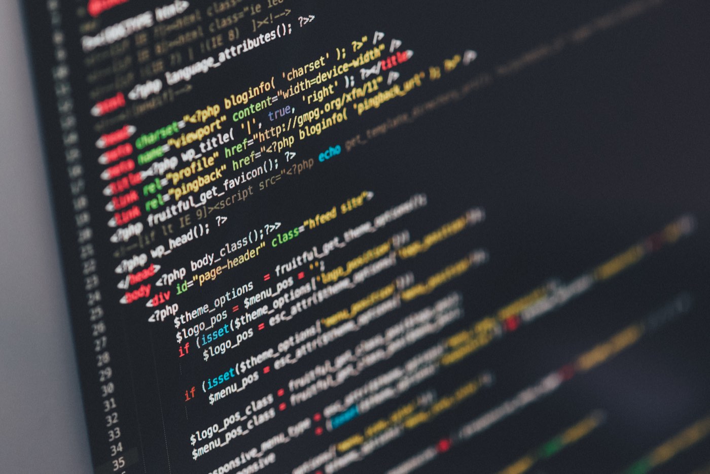 Two developers pair on code at a shared desk